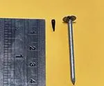 Image of a small tack next to a large nail for comparison